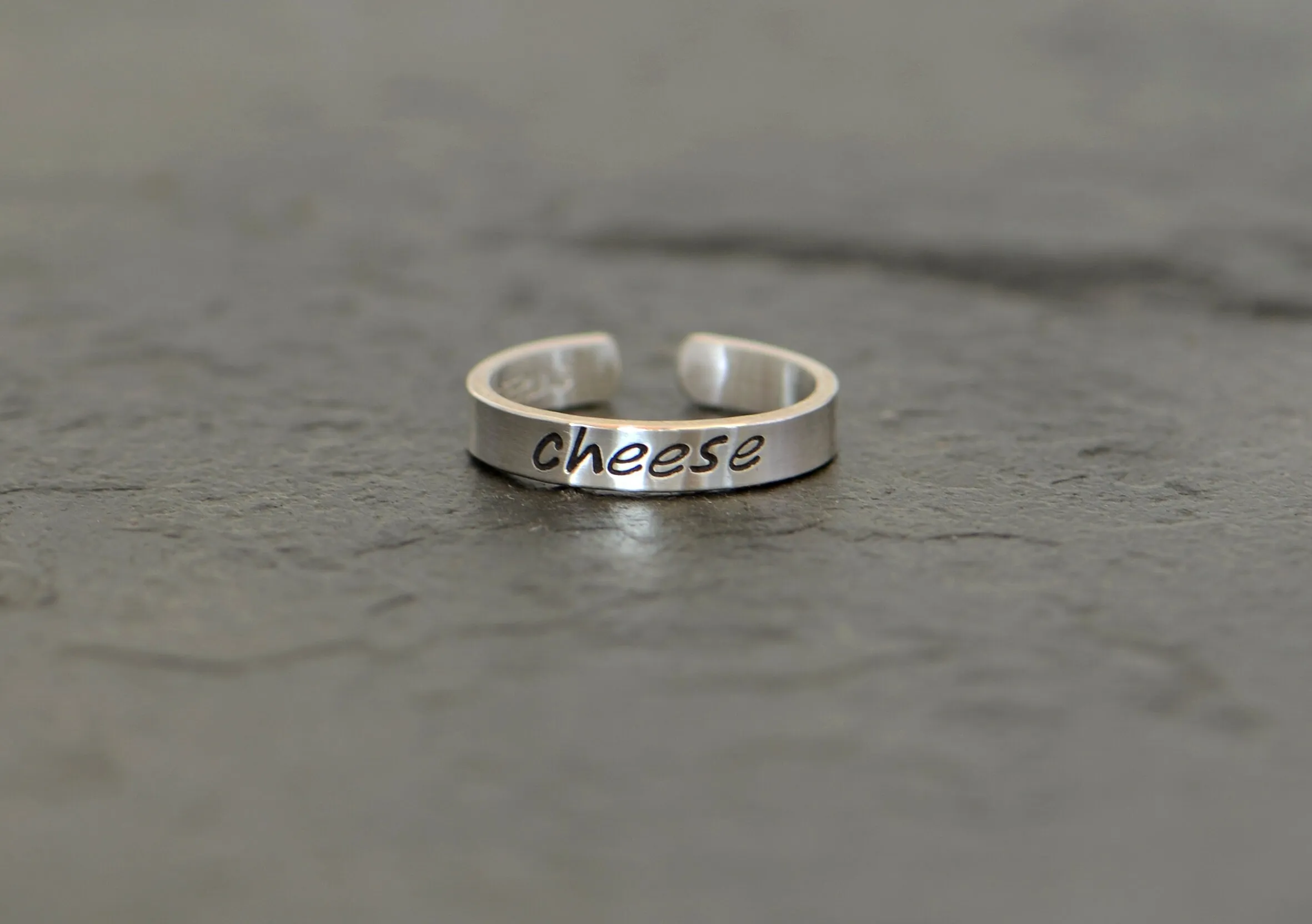 Sterling silver toe ring stamped with cheese in dainty style