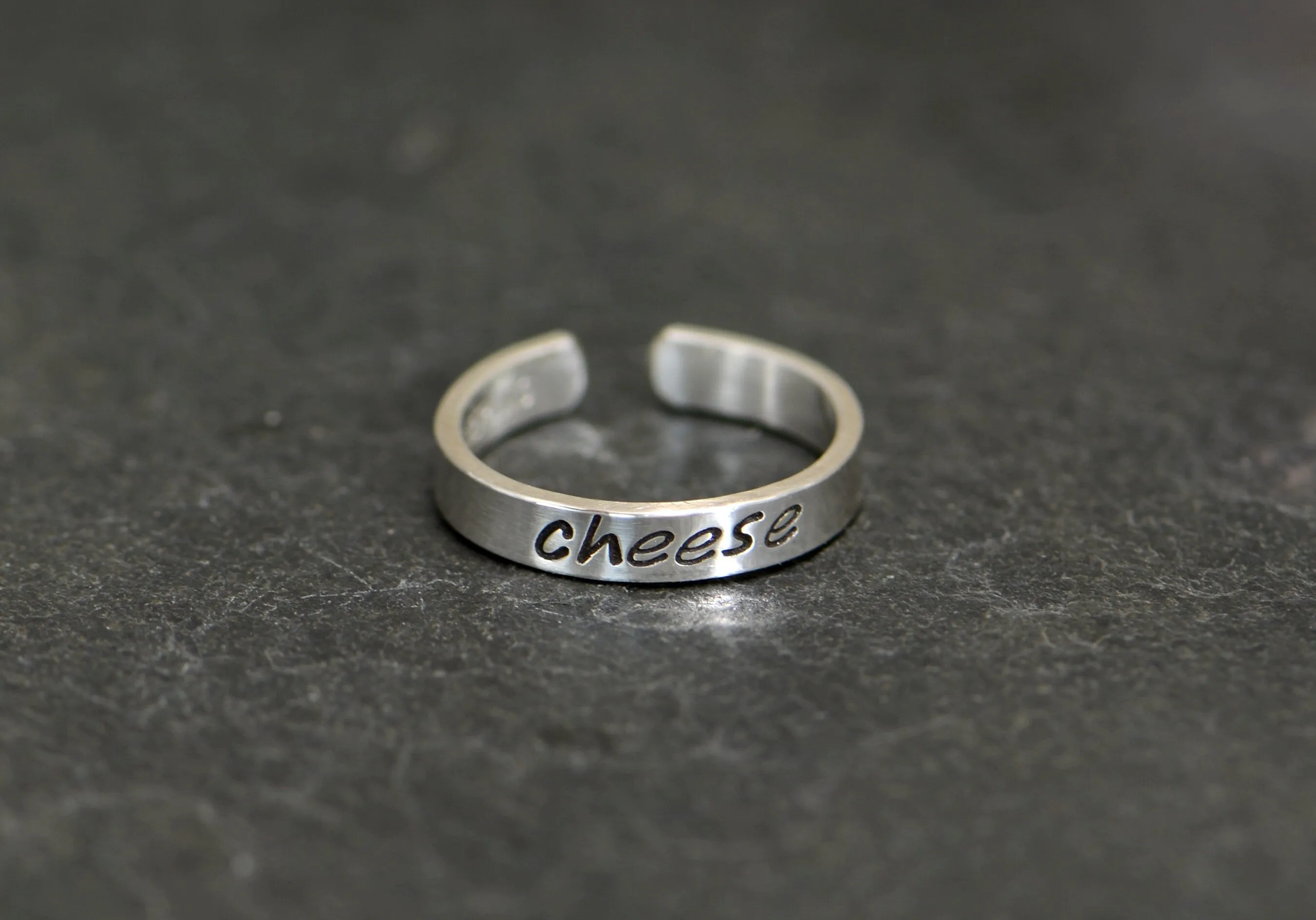 Sterling silver toe ring stamped with cheese in dainty style