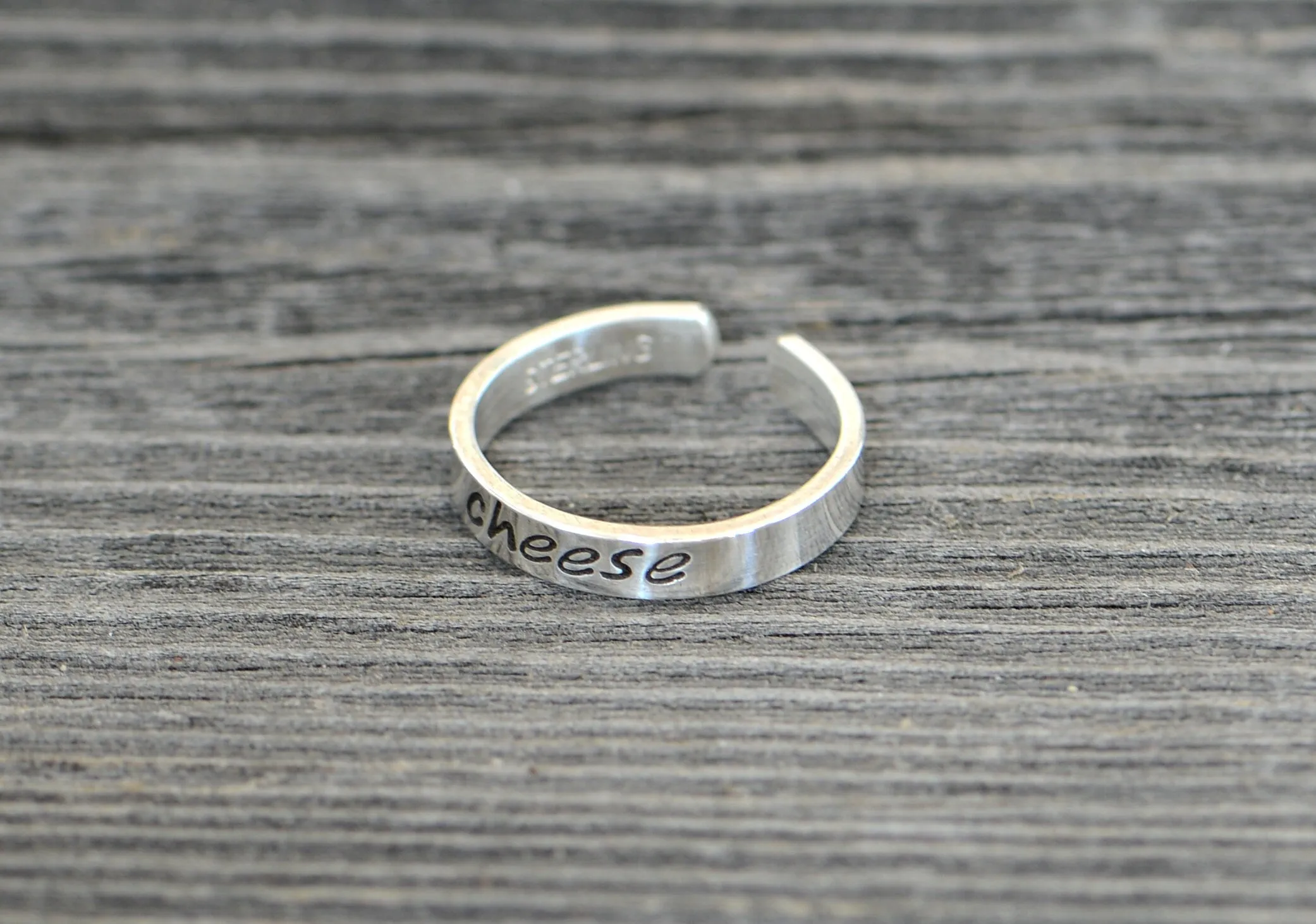Sterling silver toe ring stamped with cheese in dainty style